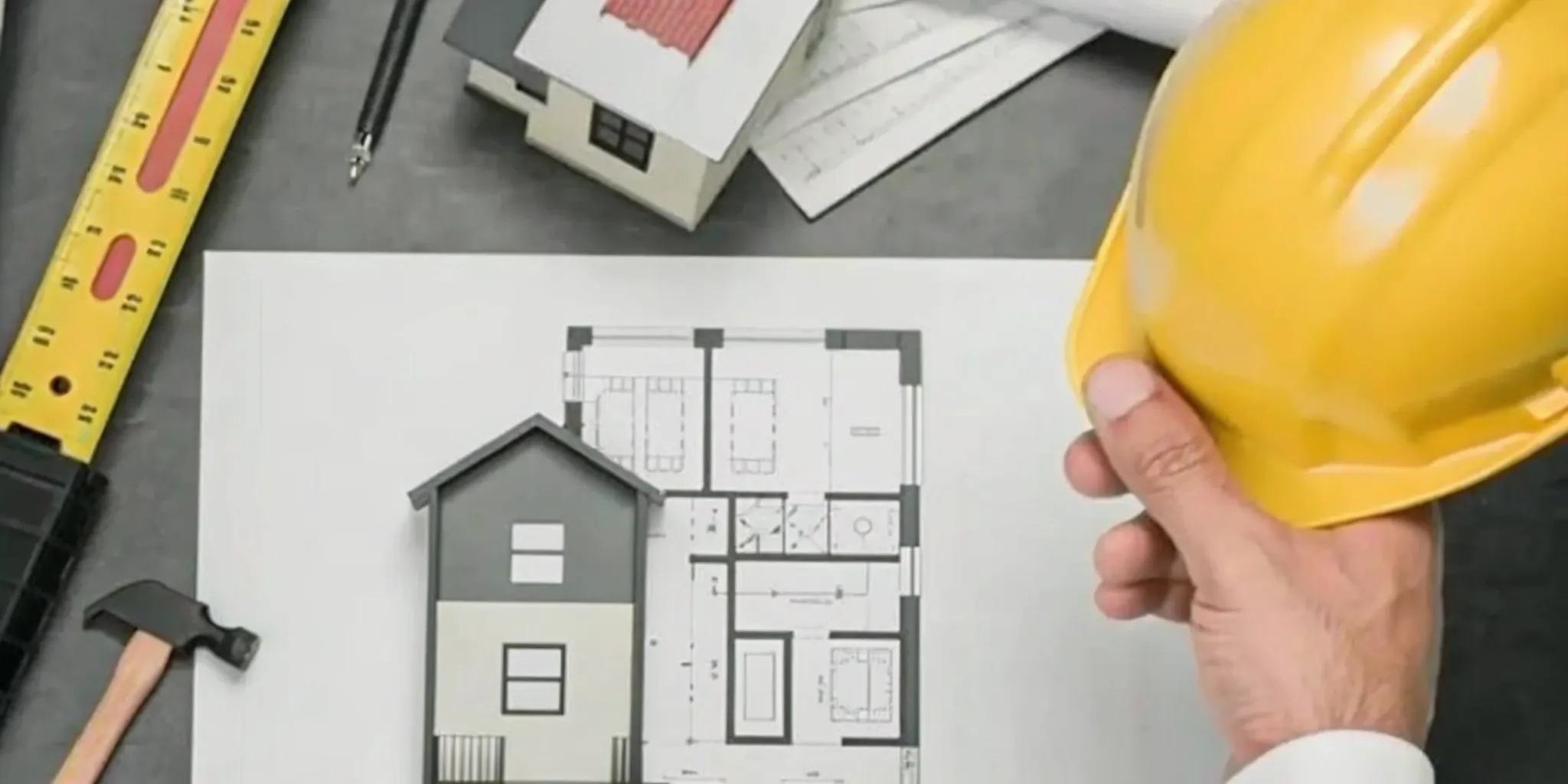 An ADU contractor reviewing floor plans, a vital step to find and hire the best professional.