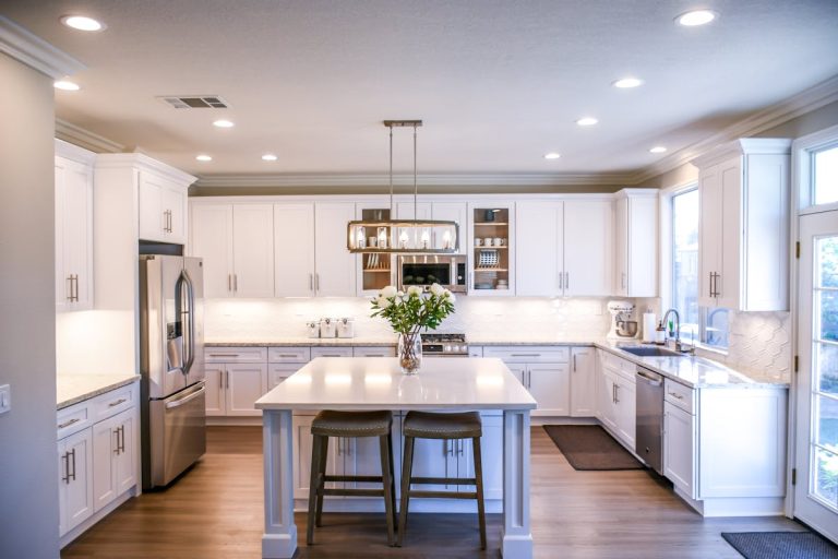 Modern Denver kitchen remodel with white oak cabinets, quartz countertops, and pendant lighting over a large island