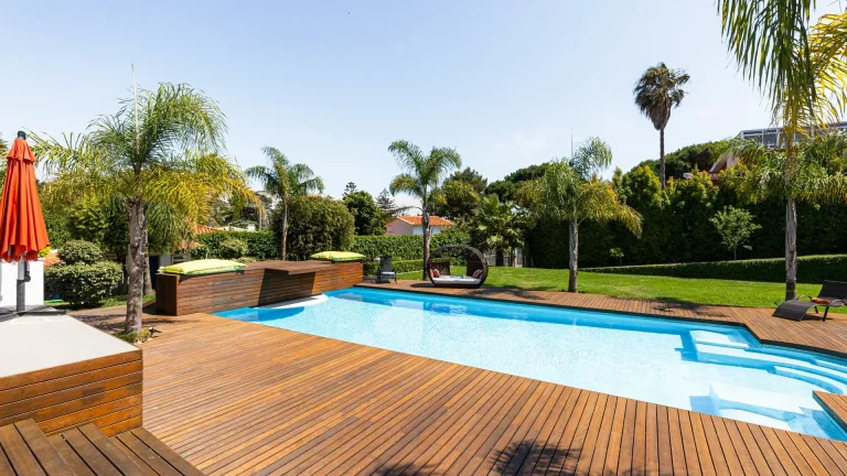 Stamped concrete pool deck surrounding an inground swimming pool in a Denver backyard