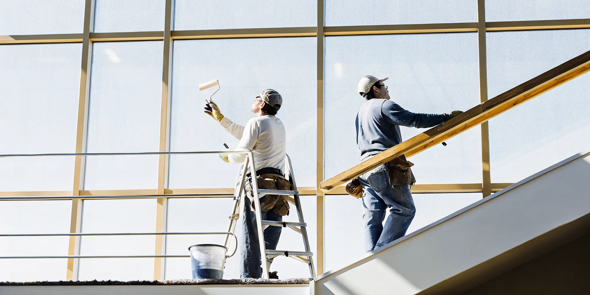 A professional painting crew painting a modern commercial office building interior during after-hours