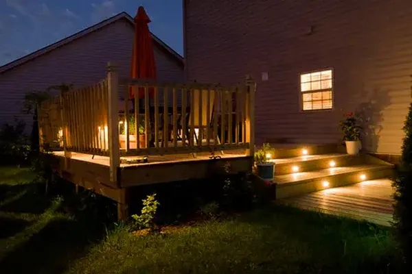 Finished residential deck with cable railings and wide stairs behind a Colorado home near Littleton